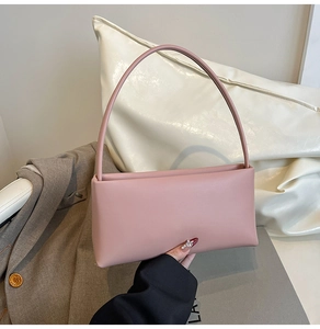 Detail of elegant dusty pink rectangular shoulder bag in smooth matte premium leather