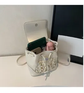 Spacious interior of off-white mini drawstring bucket bag with pearl grid detailing