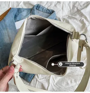 Detailed interior view showing multi-compartment lining and leather texture of the tote bag