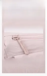 Detail of high-quality smooth zipper on pink waterproof Oxford fabric messenger bag