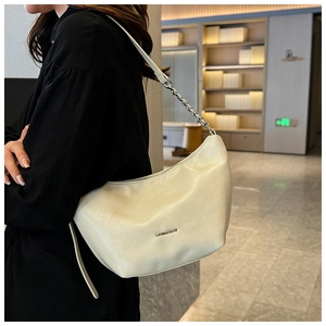Close-up of the cream hobo shoulder bag featuring a silver chain strap and logo detail