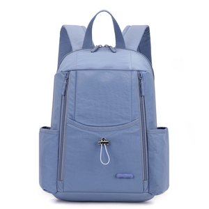 Detail view of large grey-blue nylon backpack with drawstring and front zipper pocket