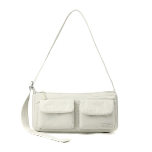 Macro detail of cream nylon crossbody bag featuring double flap pockets and textured fabric