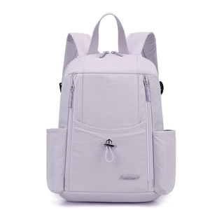 Detail view of lavender nylon backpack featuring multiple zip pockets and drawstring closure