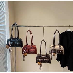 Detailed display of vintage Boston bags in black, red, and brown with metallic buckled pockets