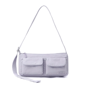 Detail of light purple nylon messenger bag showing double front pockets and texture