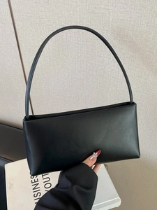 Minimalist black leather shoulder bag with sleek rectangular design and slender handle