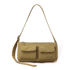 Detail view of khaki nylon messenger bag showing two front utility cargo pockets