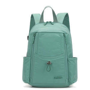 Detail view of mint green nylon backpack showing waterproof fabric and multiple pockets