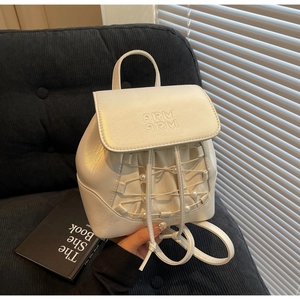 Detail of cream mini backpack with ARM ARM embossing, pearl drawstring and ribbon design