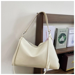 Detail view of cream beige hobo tote bag featuring soft wrinkled faux leather texture
