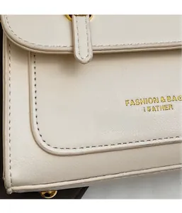 Detail of white leather handbag showing fine stitching and gold buckle hardware