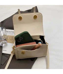 Interior view of cream white crossbody bag showing spacious capacity and organized pockets