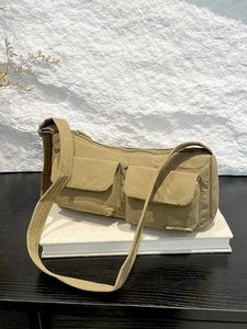 Khaki nylon vintage messenger bag with multi-pocket utility design and long shoulder strap