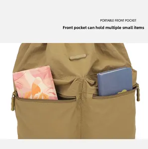 Detail of khaki nylon backpack featuring dual front zipper pockets for portable storage