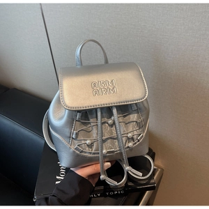 Detail of silver mini backpack featuring ARM ARM embossing and pearl mesh drawstring