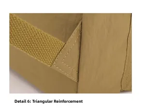 Close-up of reinforced triangle stitching on nylon drawstring backpack for durability