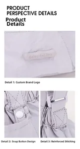 Detail view of brand logo, snap button closure, and reinforced stitching on light purple bag