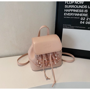 Detail of pink PU leather backpack with beige mesh, cross-lacing and white pearl accents