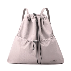 Macro detail of lavender grey nylon fabric and branded logo on drawstring backpack