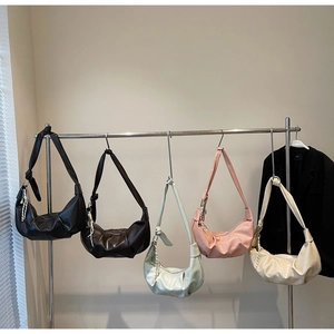 Detail of multi-color crescent hobo bags with pleated leather and woven knot handle
