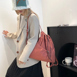 Close-up of terracotta nylon drawstring backpack with waterproof texture and large pocket