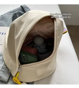 Detail view of spacious beige sling bag interior with phone and bottle storage