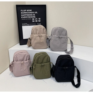 Detailed view of casual crossbody bags in khaki, grey, purple, olive and black finishes
