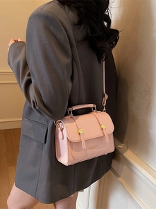 Pink leather crossbody messenger bag with gold hardware and top handle for women