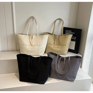 Detailed collection of minimalist canvas tote bags in four neutral colors with embossed text