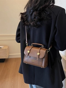 Brown vintage leather crossbody bag for women with round metal buckle and handle