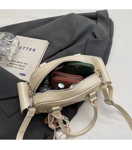 Interior view showing the large capacity of the beige pillow bag with daily essentials