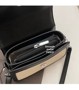 Détail du sac bandoulière tissé avec finitions en cuir et fermeture éclair argentée fluide