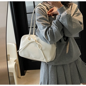 Detailed view of the large white fashion tote featuring a stylish bow and smooth PU leather