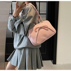 Close-up of a pink bow tote bag showing soft matte texture and large ribbon detail
