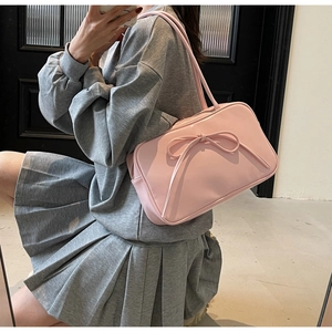 Detailed top-down view of pink bow tote bag showing matte texture and dual shoulder straps
