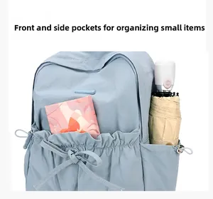 Macro detail of nylon backpack featuring drawstring front pocket and side bottle holder