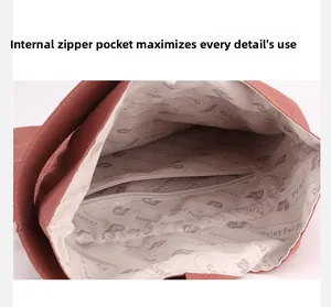 Close-up of the internal compartment and zipper pocket in a pink nylon handbag