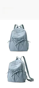 Front and side view of casual nylon backpack with drawstring pockets and bow details