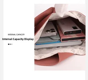 Top view of pink nylon bag interior showing capacity for tablet, phone, and power bank