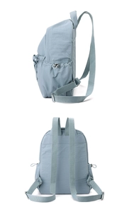 Detail view of water-resistant nylon backpack with side drawstring pocket and straps