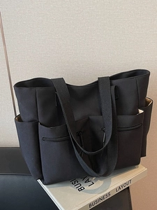 Minimalist black multi-pocket canvas tote bag with spacious capacity for daily work commuting