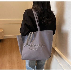 Model view of large canvas tote bag in lavender grey for daily student commute