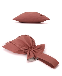 Detailed view of a terracotta minimalist nylon drawstring handbag for modern women