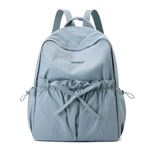 Detail of light blue nylon backpack with bow pleat pocket and Colorful Fox logo