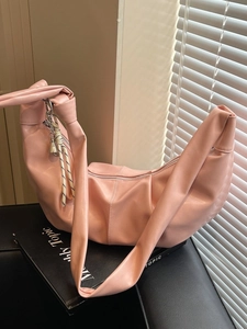 Pink crescent shoulder bag with pleated PU leather and decorative woven rope charm