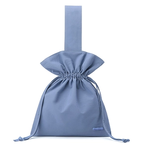 Close-up of Morandi blue drawstring bag with high-density nylon texture and logo detail