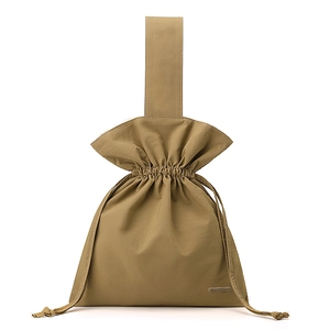 Detail of khaki nylon bucket bag with drawstring closure and wide top handle strap