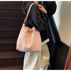 Detail of pink canvas bucket bag with colorful rainbow wave embroidery and drawstring