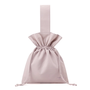 Detail of light pink nylon pouch showing drawstring closure and soft fabric texture